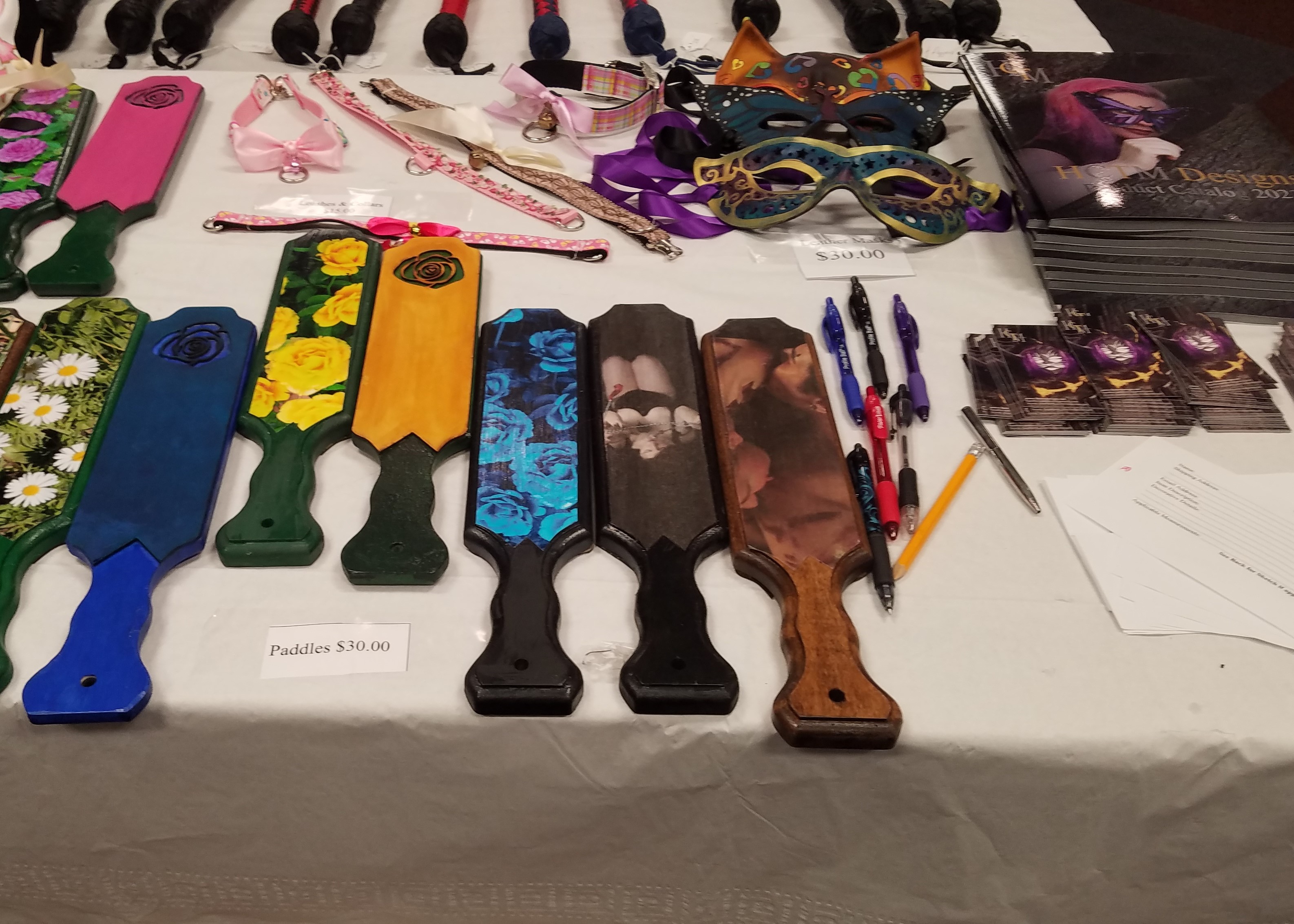 Photo of the rose paddles at a booth at Rochester Erotic Arts Festival.