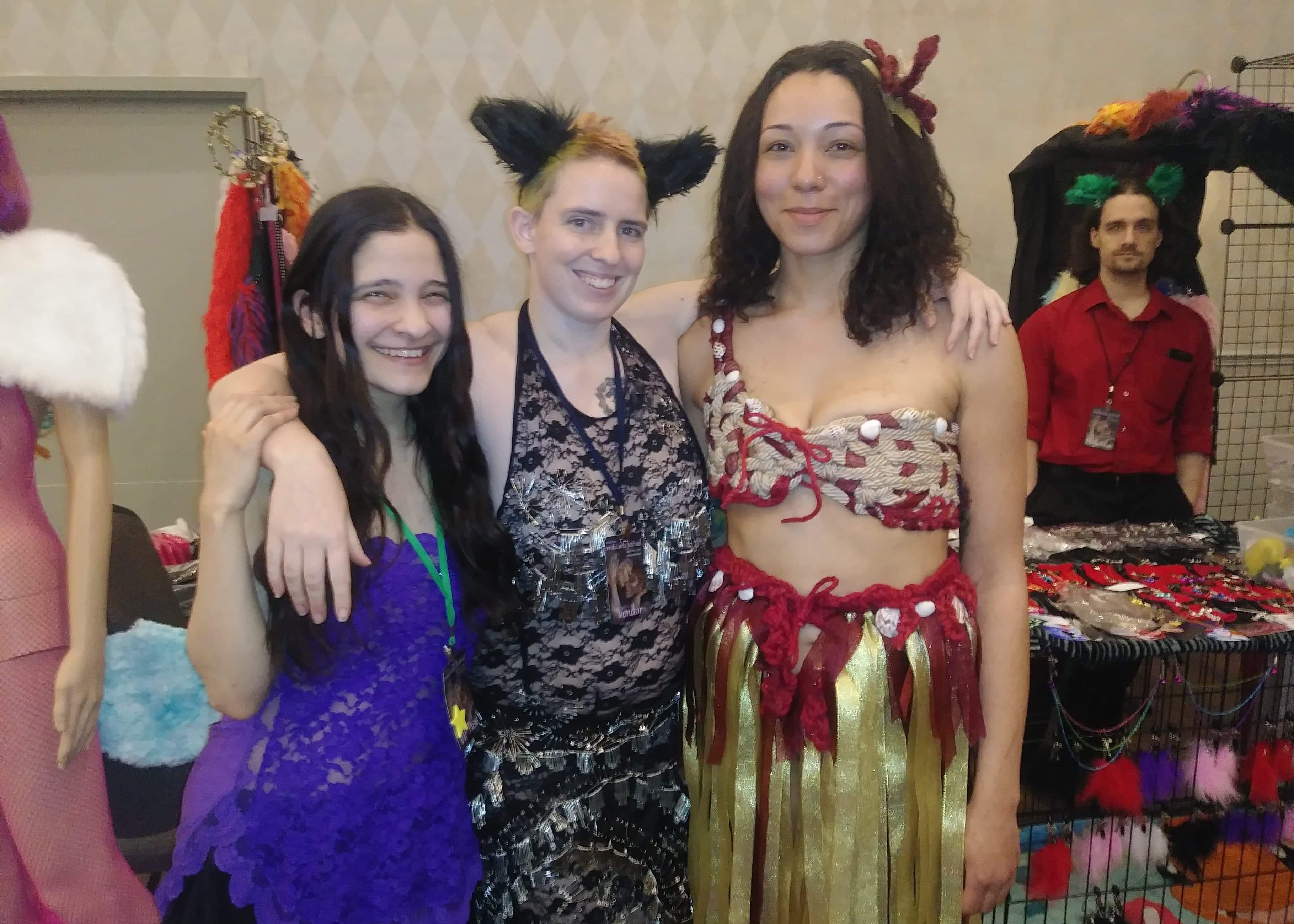 Picture of Dark haired lady in blue lace, Red-hair Cat Lady in black lace, and Moana in Rope.